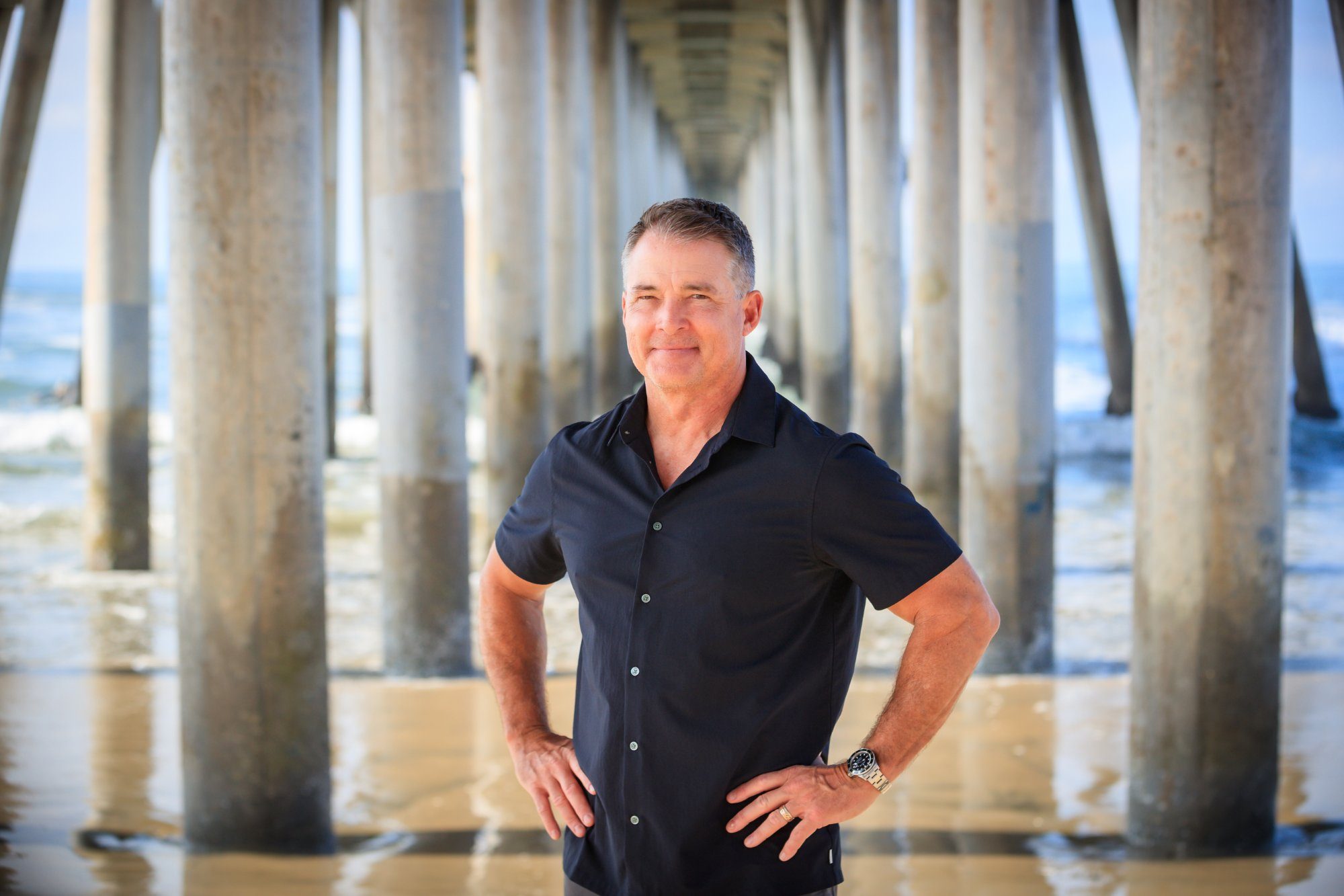 Gregg Knight standing under the Huntington Beach pier